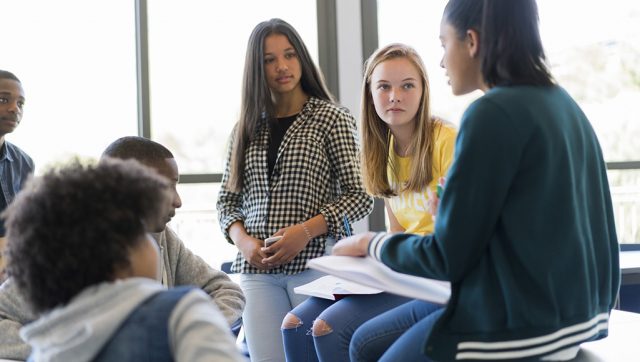 Multi-ethnic students discussing in classroom